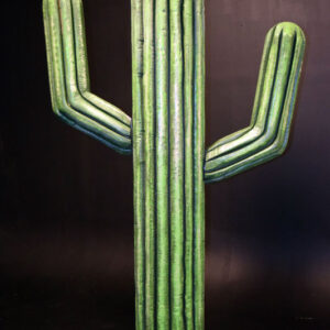 A green Cactus Cutouts standing on a black background.