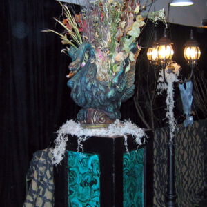 A table with a Swan Planter on it.