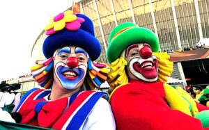 Two clowns dressed in colorful costumes entertain at a Carnival Theme Party.