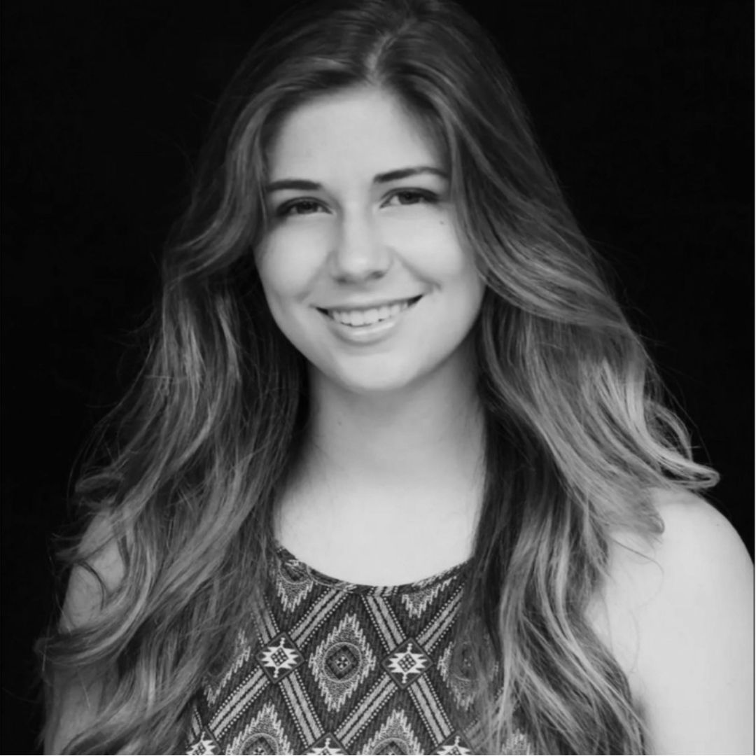 About Us: A black and white photo of a woman smiling.