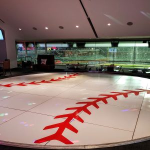 A circular dance floor adorned with a baseball, serving as a themed decor for a sports-inspired party or event.