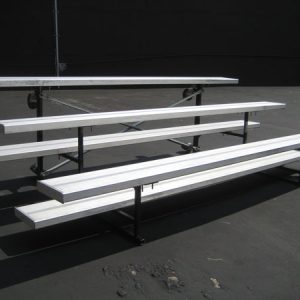 A group of bleachers utilized for corporate event rentals in a parking lot.