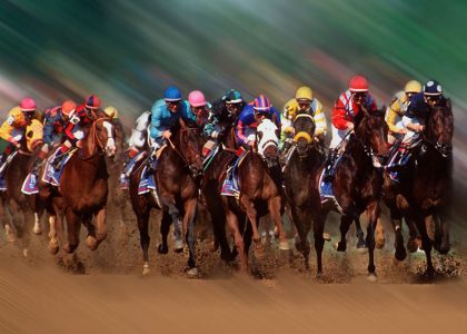 A group of jockeys are participating in a Corporate Outing Game on a dirt track. Derby Party Decor