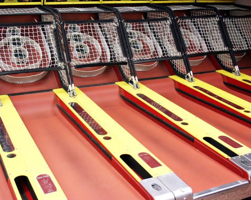 A row of tennis rackets available for rental. Decor and Prop Rentals